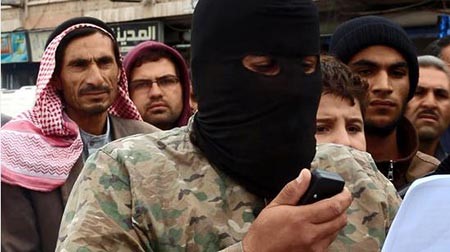 بالصور.. داعش يضع رؤوس سوريين على جذع شجرة ويقطعها بحد السيف