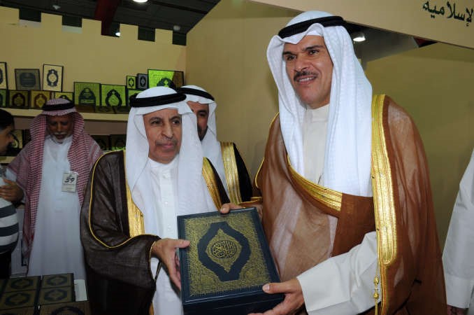 السفير السعودي يقدم مصحفا هدية للحمود لدى زيارته جناح السعودية في المعرض