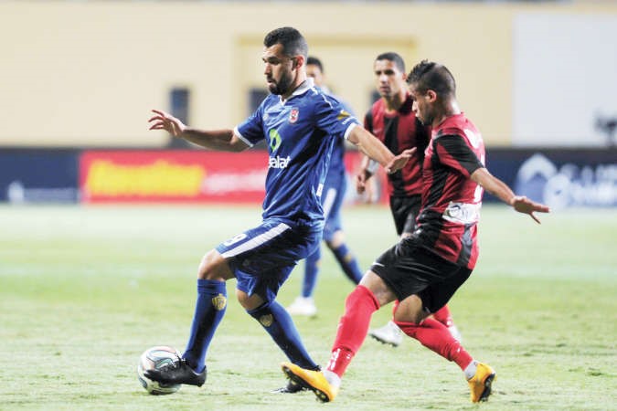 لاعب الاهلي عبدالله السعيد يحاول المرور من مدافع الداخلية