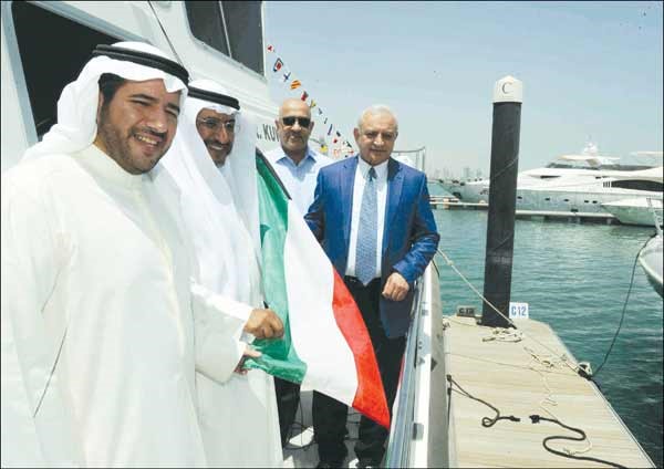 د بدر العيسى والشيخ عبدالله الاحمد ود ناجي المطيري يرفعون علم الكويت على قارب باحث 1	هاني عبدالله