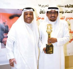 الفنان ولد الديرة في لقطة تذكارية مع السدحان بعد تكريمه﻿