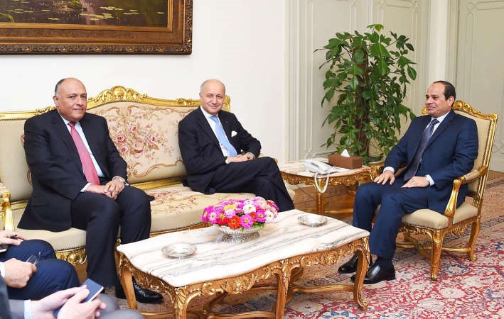 الرئيس المصري عبدالفتاح السيسي مستقبلا وزير الخارجية الفرنسي لوران فابيوس بحضور نظيره المصري سامح شكري امس الاول افپ