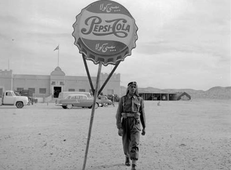 شرطي يسير في الكويت امام اعلان لشركة بيبسي عام 1955
