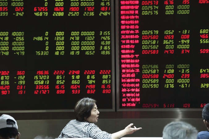 مستثمرة في الاسهم الصينية امام شاشة تعرض الاسعار في البورصة الصينية وذلك عقب التدخل الحكومي الاسبوع الماضي الذي هدا نزيف الاسعار واعاد اللون الاخضرافپ﻿