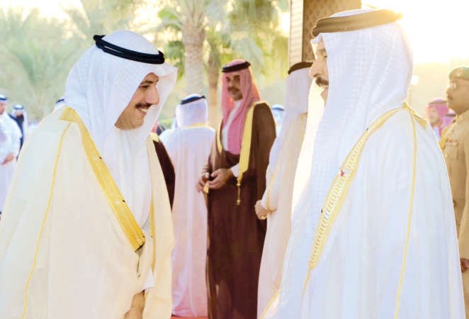 العاهل البحريني الملك حمد بن عيسى مصافحا السفير الشيخ عزام الصباح ﻿