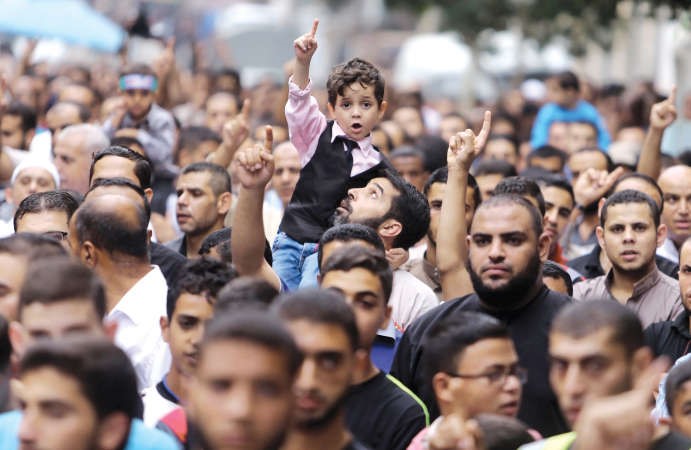 طفل فلسطيني يشارك في مظاهرة قطاع غزة ضمن مسيرات حاشدة في يوم الغضب	رويترز﻿
