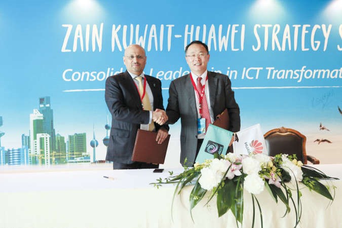 عمر العمر الرئيس التنفيذي لـ زين الكويت وديفيد وانغ رئيس خط منتجات هواوي للشبكات اللاسلكية بعد توقيع الاتفاقية 