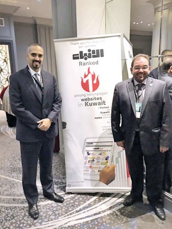 الشيخ مشعل الجابر والزميل يوسف خالد المرزوق بجانب استاند الانباء خلال مشاركتهما بالمؤتمر