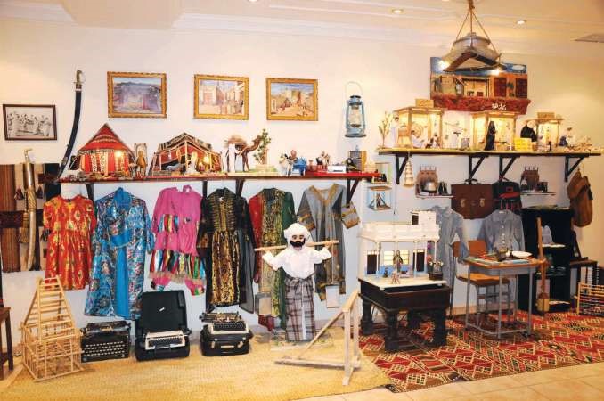 الكندري يحمل الماء وسط بعض المعروضات التراثية﻿