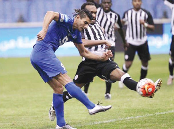مهاجم الهلال ايلتون الميدا يسدد الكرة بمضايقة من لاعب الشباب