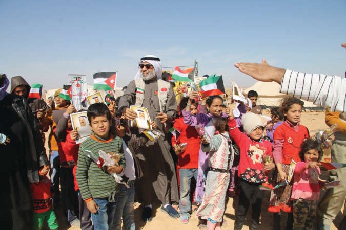 الاطفال يحملون علم الكويت وصور صاحب السمو﻿