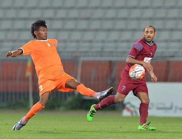 مدافع كاظمة احمد عتيق يبعد الكرة من امام لاعب النصر منذر ابوعمارة