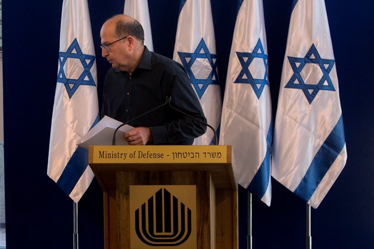 وزير الدفاع الاسرائيلي المستقيل موشيه يعالون مغادرا المؤتمر الصحافي امس اپ