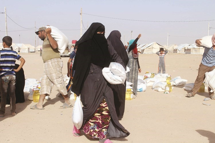 نازحون عراقيون من الفلوجة يتلقون المساعدات الانسانية الاممية امس الاول افپ
