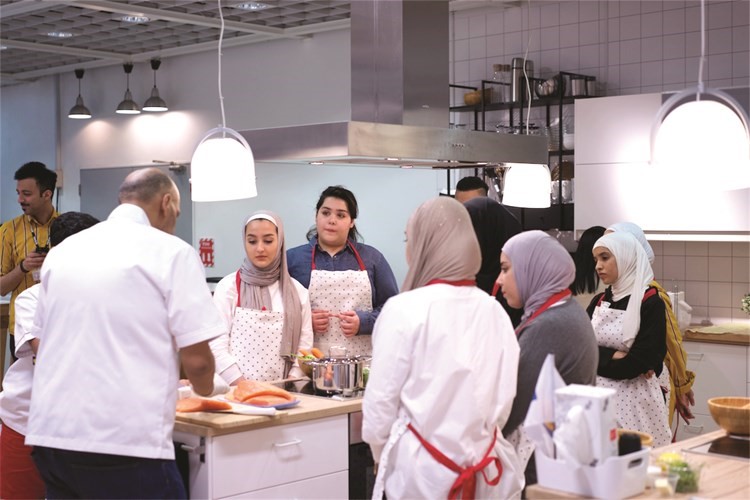 متابعة من بعض المشاركات للشيف اثناء اعداد احدى الوجبات﻿
