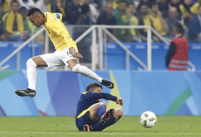 نجم البرازيل نيمار يقفز فوق الحارس الكولومبي كريستيان بونيلاافپ﻿