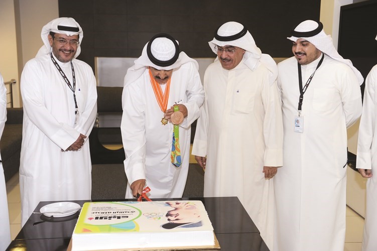 البطل البرونزي الرشيدي يقطع الكيكة بحضور الزملاء عدنان الراشد ومبارك الخالدي وعبدالعزيز جاسم﻿