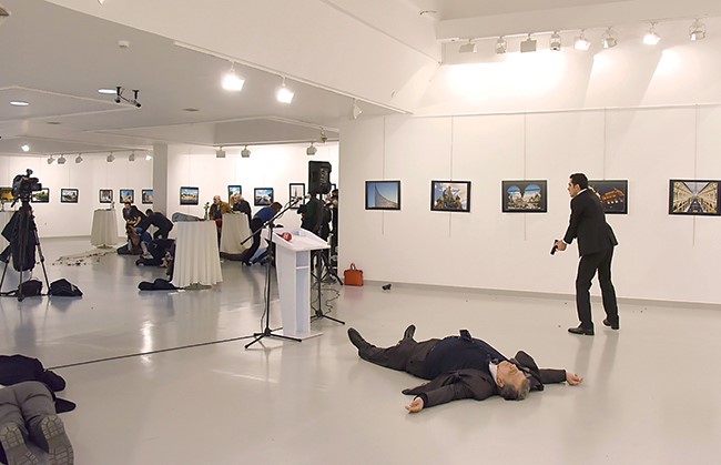  جثة السفير الروسي ممددة على الأرض وإلى جانبه مطلق النار وفي الإطار القاتل بعد تنفيذ جريمته صارخا «الله أكبر» ثم مضرجا في دمائه بعد مقتله 	(أ.ف.پ)
