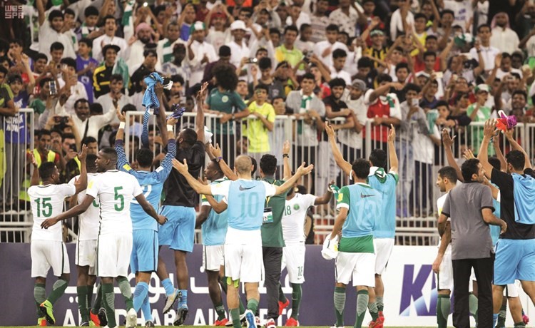 لاعبو السعودية يحتفلون مع الجماهير الحاضرة في الملعب ﻿