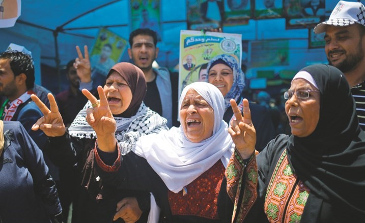 فلسطينيات يرفعن شارة النصر خلال مسرة تضامنية مع الاسرى في غزة امس(ا.ف.پ)﻿