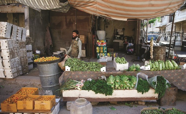 سوري يبيع الخضار عشية رمضان في دوما التي يسيطر عليها المعارضون في الغوطة الشرقية	(رويترز)﻿