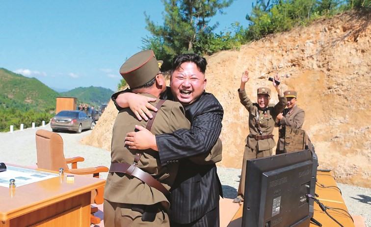 ﻿الزعيم الكوري الشمالي كيم جونغأون معانقا أحد جنرالاته عقب الإطلاق الناجح للصاروخ الباليستي أول من أمس (أ.ف.پ)﻿