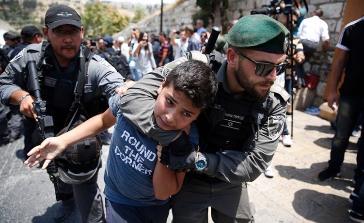 قوات الاحتلال الاسرائيلي لحظة اعتقالها طفلا فلسطينيا خلال تظاهرة امام إحدى بوابات الاقصى امس			 (أ.ف.پ) ﻿