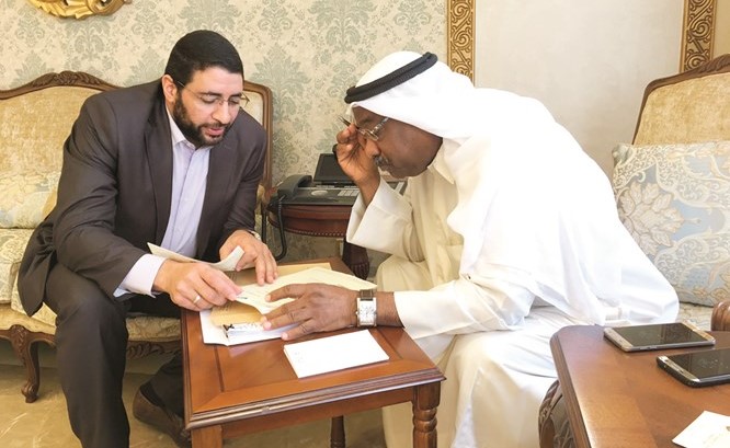 د. الخشتي ينظر في احدى الشكاوى مع أحد العاملين بالوزارة﻿