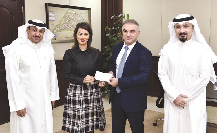 التجاري مقدما شيك المساهمة إلى مدير عام الهيئة العامة للصناعة بالتكليف﻿