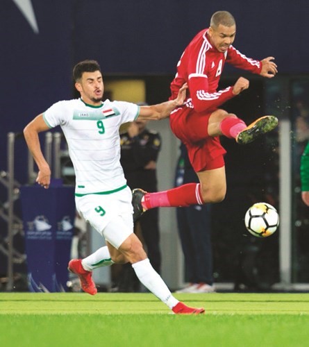منافسة على الكرة بين المدافع الاماراتي اسماعيل احمد والعراقي ايمن حسين ﻿