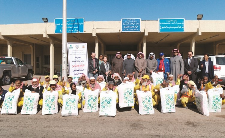 مسؤولو البنك التجاري ومحافظة الفروانية مع عمال البلدية خلال الحملة ﻿