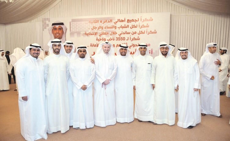 عبدالله المحري متوسطا مجموعة من الشباب المهنئين ﻿