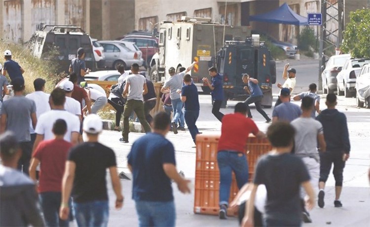 مواجهات بين الفلسطينيين وقوات الاحتلال في مخيم الامعري بالضفة امس الاول-(أ.ف.پ)﻿