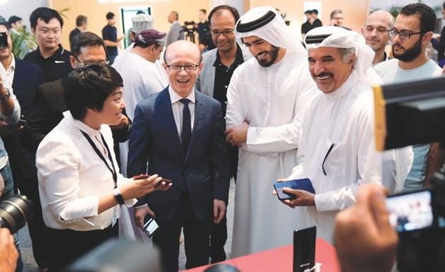 جين جياو وسعيد حارب وعاصم كاظم خلال اطلاعهم على سلسلة Huawei Mate20 ﻿
