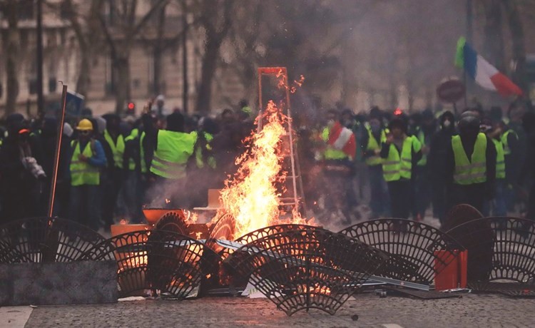متظاهرون يحرقون احد الحواجز التي اقاموها لاغلاق الطرق في باريس	 (أ.ف.پ)﻿