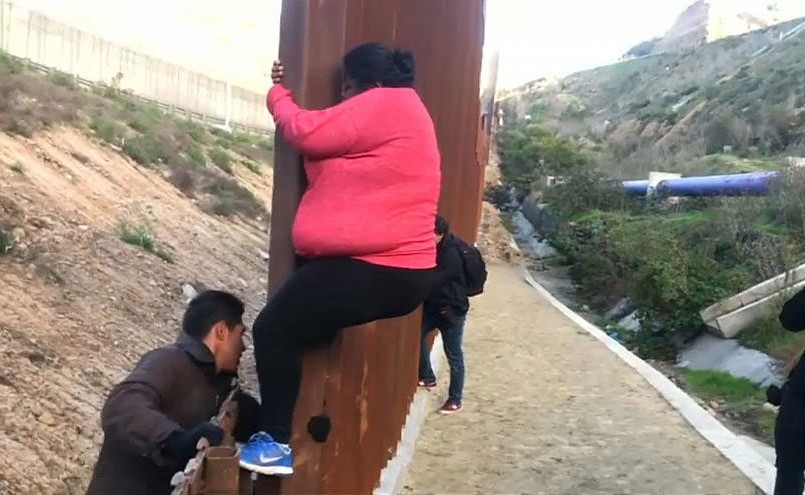 بالفيديو.. مهاجرون يتسلقون السياج الحدودي في المكسيك للعبور إلى الولايات المتحدة