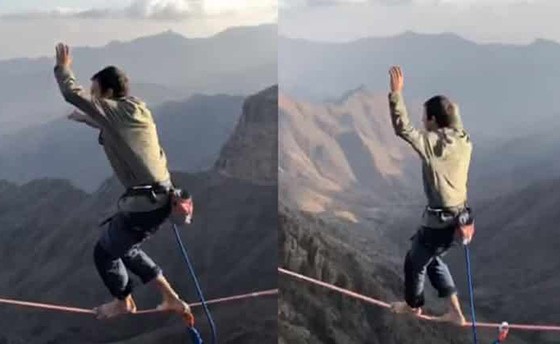 بالفيديو.. مغامر حافي القدمين يسير على حبل يصل جبلين شاهقين بالسعودية