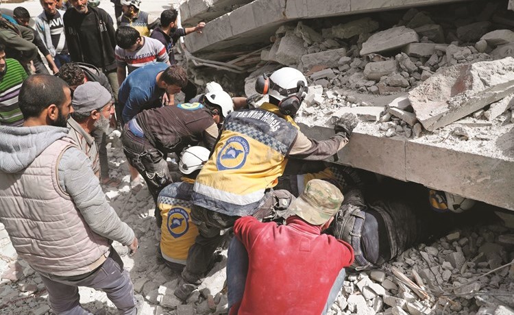 ﻿عمال انقاذ يبحثون عن عالقين تحت انقاض المباني التي دمرها انفجار جسر الشغور(أ.ف.پ)﻿
