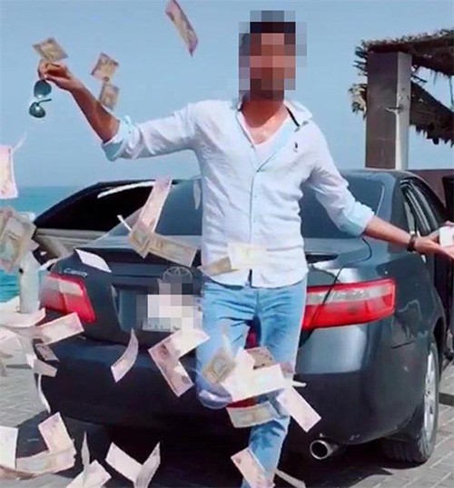 شرطة دبي تطيح بشاب ظهر في فيديو وهو يرمي الأموال في الشارع بقصد التباهي