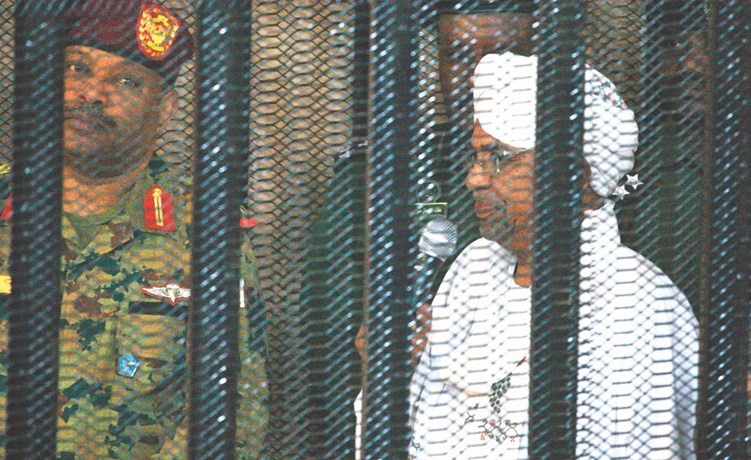 ﻿الرئيس السوداني المخلوع عمر البشير في القفص خلال اولى جلسات محاكمته بتهم الفساد أمس	(ا.ف.پ) ﻿