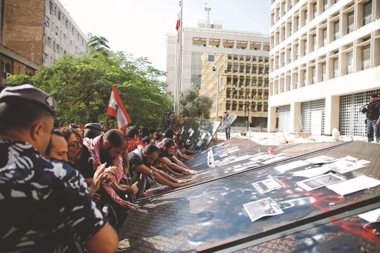 محتجون يسقطون السياج حول مصرف لبنان المركزي تزامنا مع كلمة حاكمه رياض سلامة	(رويترز) ﻿