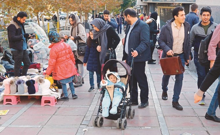 إيرانيون يتسوقون في أحد الشوارع بطهران	 (أ.ف.پ)﻿