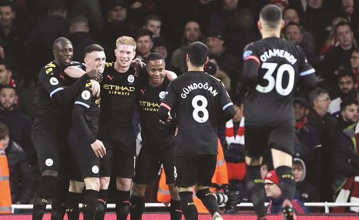 Soccer Football - Premier League - Arsenal v Manchester City - Emirates Stadium، London، Britain - December 15،2019 Manchester Citys Kevin De Bruyne celebrates scoring their third goal with teammates REUTERS/Hannah McKay EDITORIAL USE ONLY. No use with unauthorized audio، video، data، fixture lists، club/league logos or live services. Online in-match use limited to 75 images، no video emulation. No use in betting، games or single club/league/player publications. Please contact your account representative for further details.