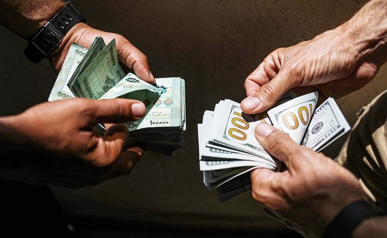 صورة ارشيفية لتبادل لبنانيين الليرة بالدولار في السوق السوداء(ا.ف.پ)