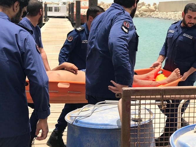 رجال الانقاذ البحري يحملون احد الشباب بعد انتشاله من عرض البحر