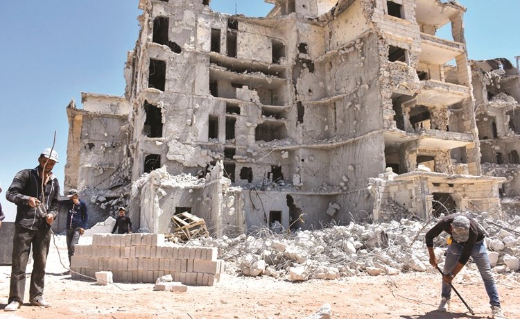 سوريون يحاولون اعادة اعمار بيوتهم في حي الزهراء بحلب	(أ.ف.پ)