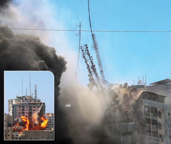 لحظة انهيار برج الجلاء بعد قصفه بغارة إسرائيلية في غزة .. وفي الإطار خلال إطلاق الصواريخ على البرج	(أ.ف.پ)
