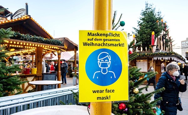 لافتة تشدد على ضرورة ارتداء كمامة الوجه أمام متجر لبيع هدايا عيد الميلاد في برلين أمس	 (أ.ف.پ)