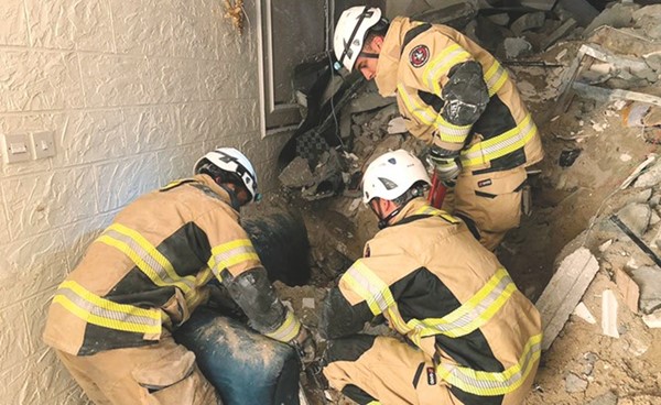 رجال الإطفاء خلال انتشال جثة السيلانية من تحت الأنقاض