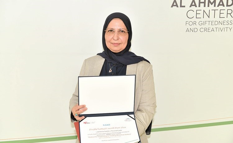 المخترعة فاطمة الثلاب مع شهادة تكريمها(أحمد علي)